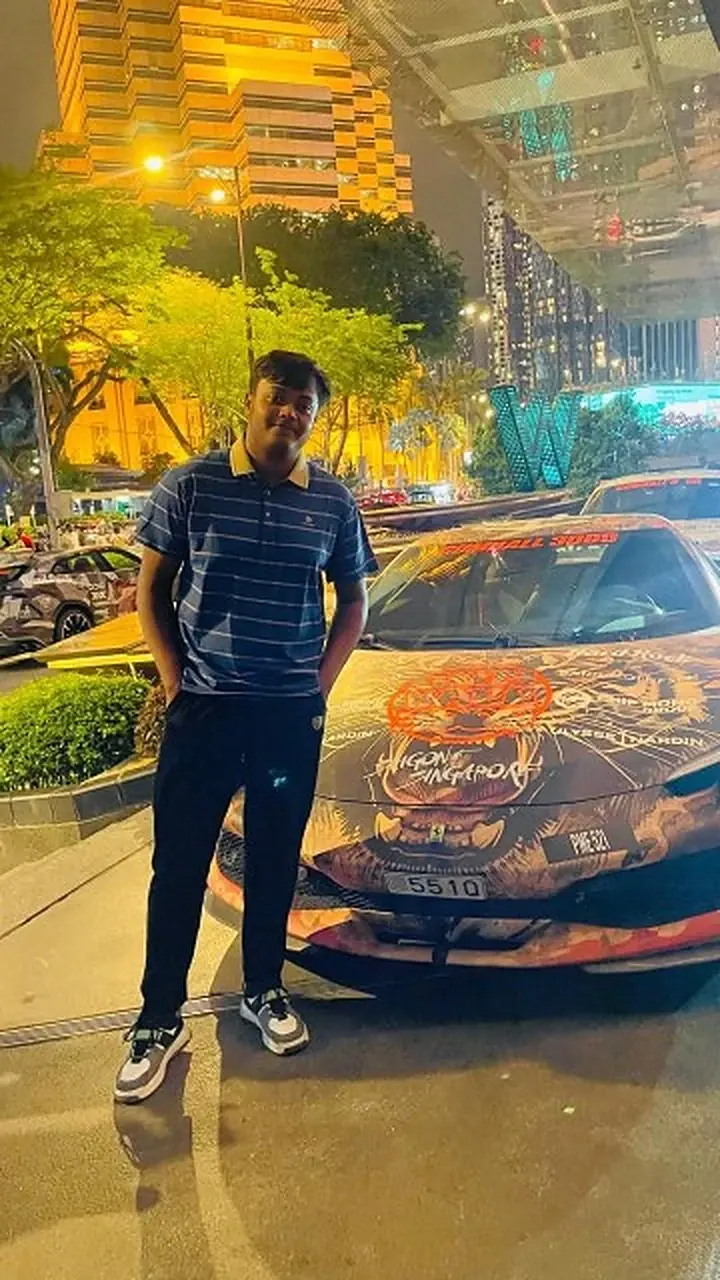 Md Saad Islam at night beside a tiger-liveried Lamborghini